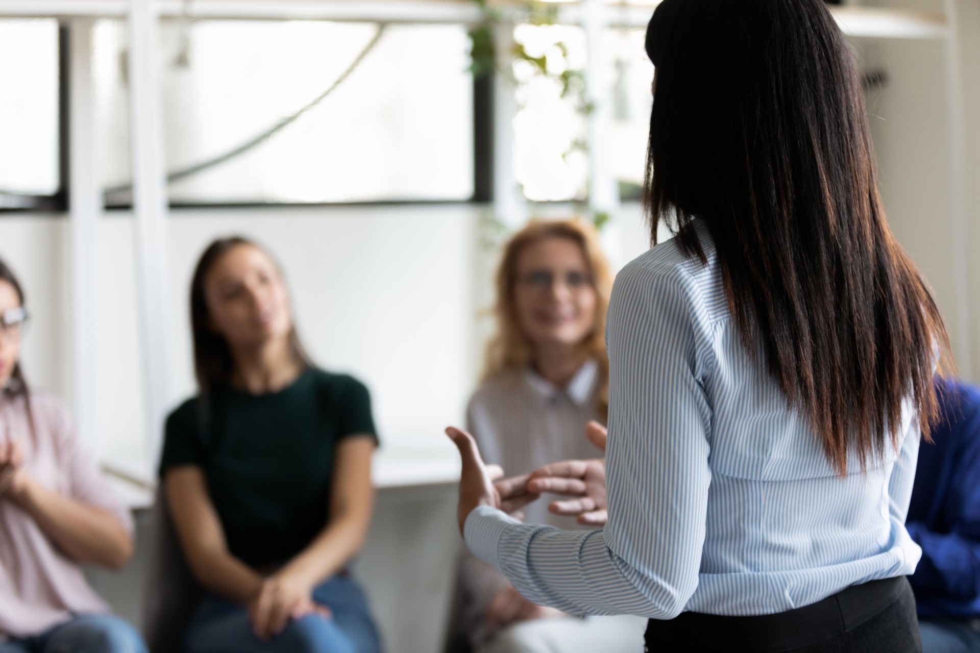 Corporate staff gathered together listening business coach at seminar